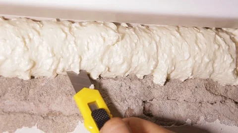 Worker cuts with a knife for paper construction foam Stock Footage 101191447