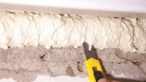 Worker cuts with a knife for paper construction foam Stock Footage 101299046
