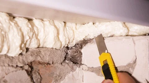 Worker cuts with a knife for paper construction foam Stock Footage 101348608