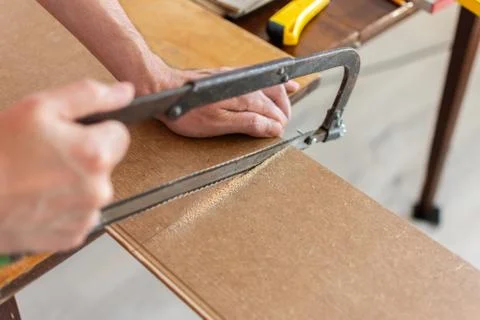 Worker cuts a laminate of a certain length Stock Photos
