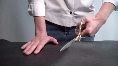 Worker cuts a large piece of leather with scissors 스톡 동영상 150230508