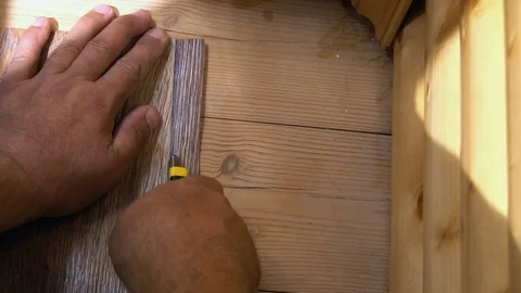 The worker cuts off the linoleum with a utility knife,fitting of linoleum floor Stock-Footage 77832545