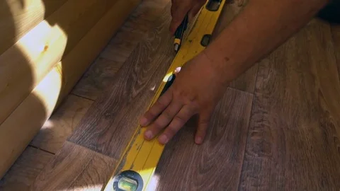 The worker cuts off the linoleum with a utility knife,fitting of linoleum floor Stock Footage 77838874