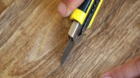 The worker cuts off the linoleum with a utility knife,fitting of linoleum floor Stock Footage 77842084