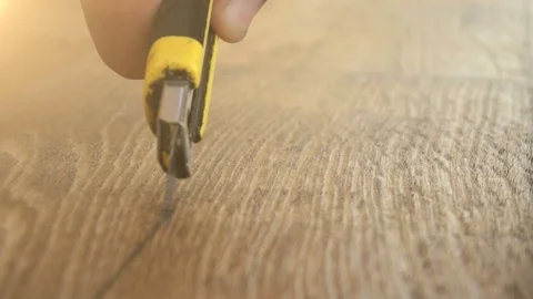 The worker cuts off the linoleum with a utility knife,fitting of linoleum floor Stock Footage 77849056
