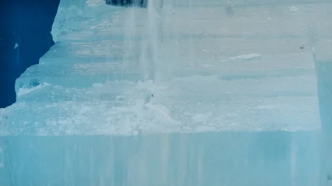 Worker cuts a lump of ice with a chainsaw. Stock Footage 104020997