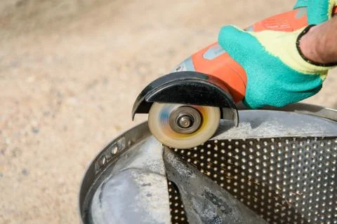 Worker cuts in metal with an angle grinder Stock Photos