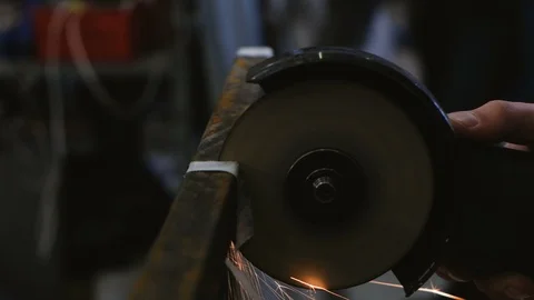 Worker cuts a metal bar of angular grinding machine, closeup Video stock 87942701