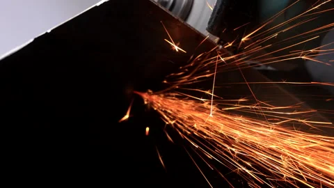 A worker cuts metal with a circular saw and makes a lot of sparks Stock Footage 276308926