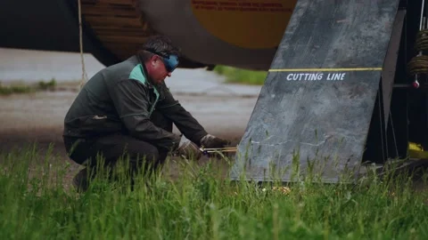 A worker cuts metal by electric welding, the process of metal welding Stock Footage 196819092
