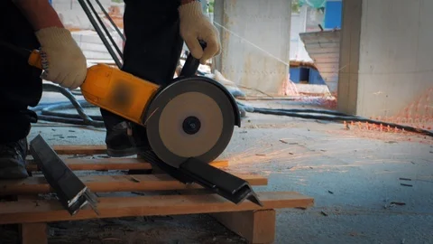 Worker Cuts Metal with Grinder Circular Blade on Construction Site, close up Stock Footage 108638240