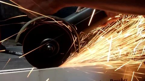 Worker cuts metal with grinding machine Stock Footage 121923994