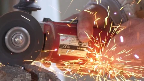 Worker cuts metal with the grinding wheel making sparks Stock Footage 73919661