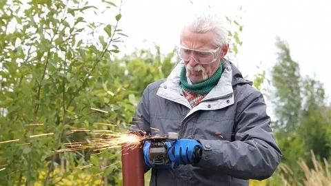 Worker cuts a metal pipe Stock Footage 80088757