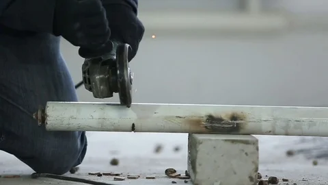 Worker cuts a metal pipe grinder Stock Footage 72558315