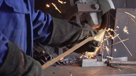Worker cuts metal pipe with a grinder. A lot of sparks. Stock Footage 104263003