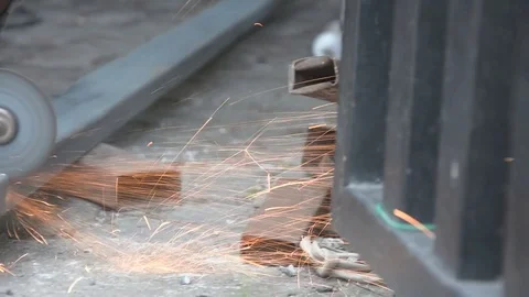 Worker cuts a metal pipe with some electric device or appliance Video stock 83787175