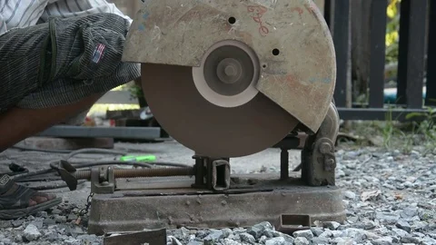 Worker cuts a metal pipe with some electric device or applianc Stock Footage 83787553