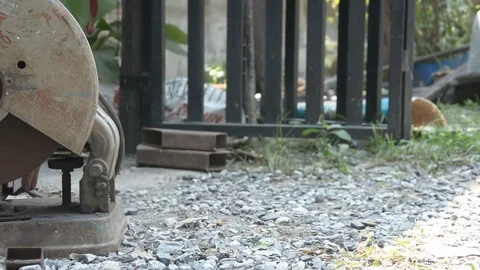 Worker cuts a metal pipe with some electric device or applianc Stock Footage 83787571