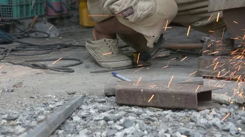 Worker cuts a metal pipe with some electric device or applianc Stock Footage 83787723