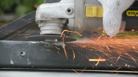 Worker cuts a metal pipe with some electric device or appliance Stock Footage 201883242