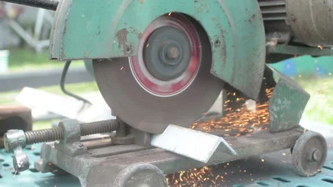 Worker cuts a metal pipe with some electric device or appliance Stock Footage 201883252