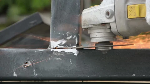 Worker cuts a metal pipe with some electric device or appliance Stock Footage 201883261