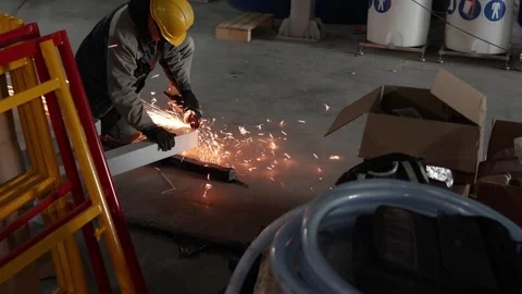 Worker cuts metal in production Stock Footage 173240470