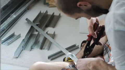 The worker cuts the metal profile Stock Footage 74817575