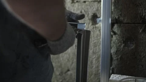 Worker cuts metal profile with scissors Stock Footage 201382548
