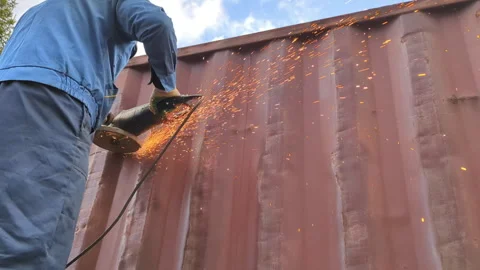Worker cuts metal with a saw, creating sparks. Stock Footage 306078884