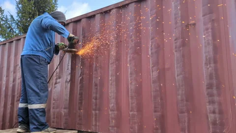Worker cuts metal with a saw, creating sparks. Stock Footage 306079020