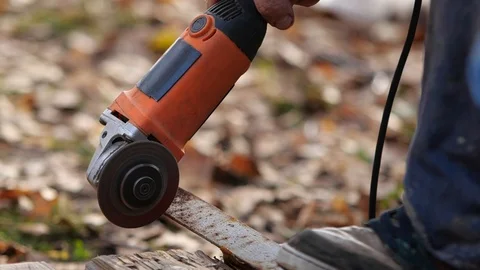 Worker cuts the metal structure with a grinding machine. Stock Footage 95968598