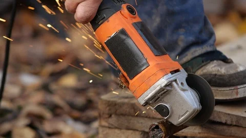 Worker cuts the metal structure with a grinding machine. Stock Footage 95968637