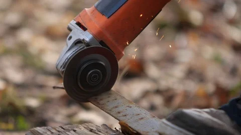Worker cuts the metal structure with a grinding machine. Stock Footage 96327042