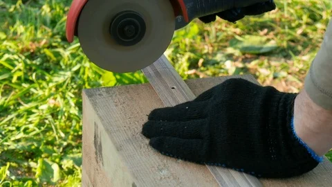 The worker cuts the metal threshold for the door by grinder. Video stock 77585891