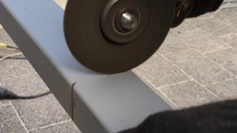 The worker cuts metal using special equipment. Metal products, metal sheet Stock Footage 285556206