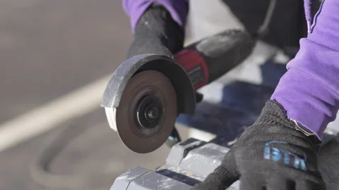 Worker cuts panel using sharp powerful angle grinder Видео 316089452