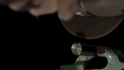 The worker cuts off a piece of metal with a cutting tool Stock Footage