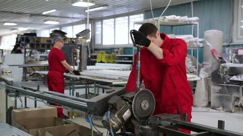 A worker cuts a profile for plastic windows. Cutting of the glazing bead for the Stock Footage 100877584