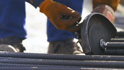 Worker cuts off rebar with a grinder Video stock 160470650