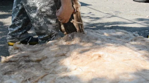 Worker cuts with scissors the rockwool for wall insulation. Close-up. Stock Footage 64733782