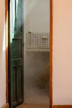 A worker cuts some concrete using a grinder, in the bathroom of a farmhouse i Stock Photos
