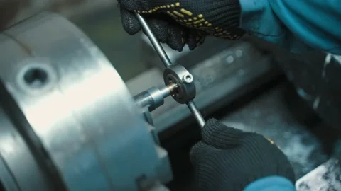 A worker cuts a thread in a metal part. Stock Footage 225875507