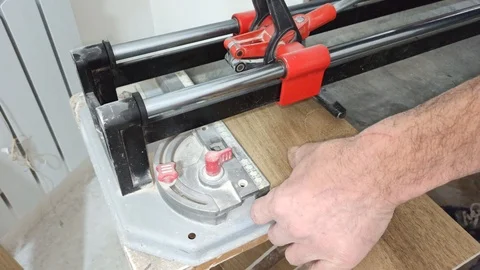 Worker cuts tiles with tile to be installed on the floor Stock Footage 124226975