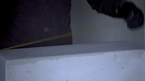 The worker cuts unit blocks in the house Stock Footage 90190926