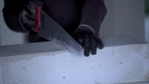 The worker cuts unit blocks in the house Stock Footage 90191236