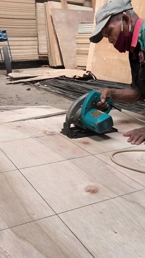 Worker cuts wood floor with circular saw Stock Footage 345099786