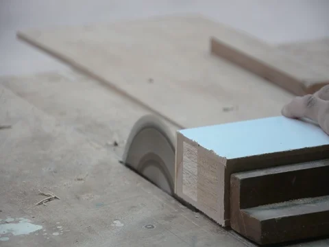 Worker cuts a wood with some electric device or appliance Stock Footage 83779304