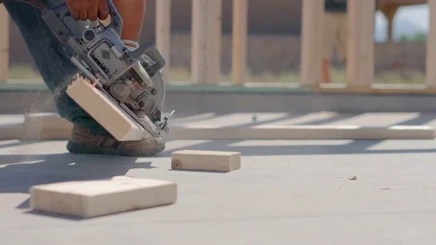 Worker Cuts Wood Using Foot as Leverage Stock Footage 80833593